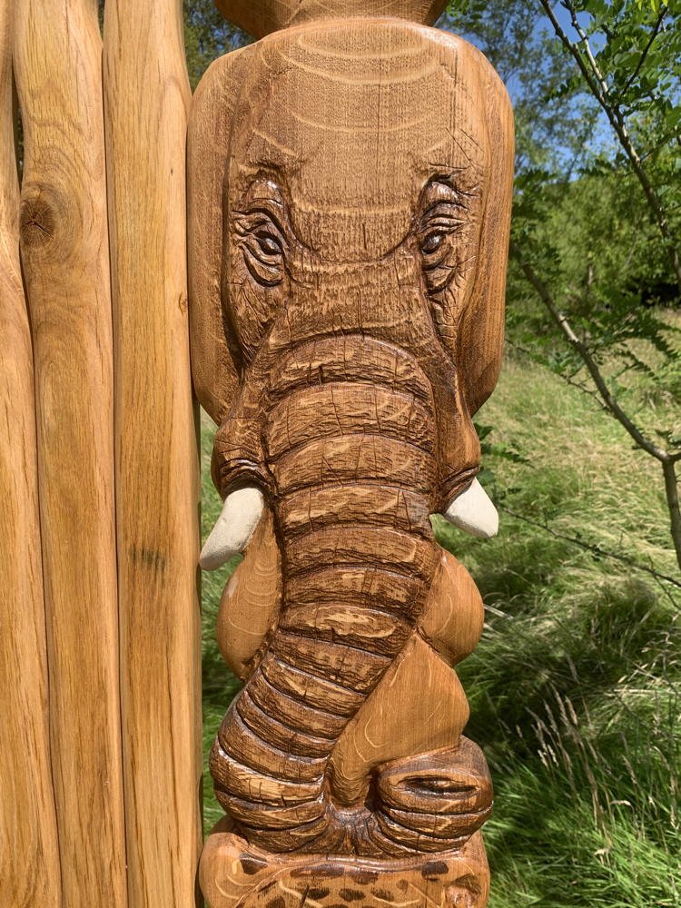 Carved elephant on handmade oak safari storytelling chair — bespoke African wildlife throne, Wales
