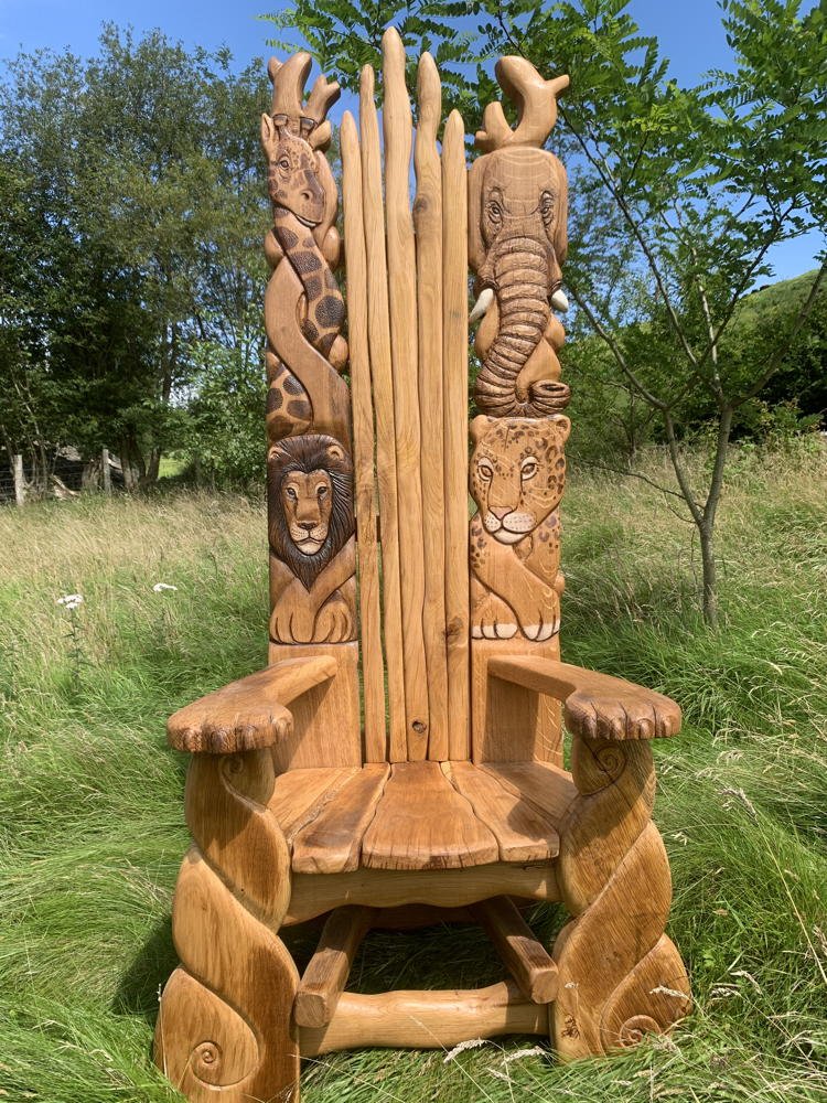 Hand-carved solid oak African safari chair — bespoke wildlife storytelling throne, Wales