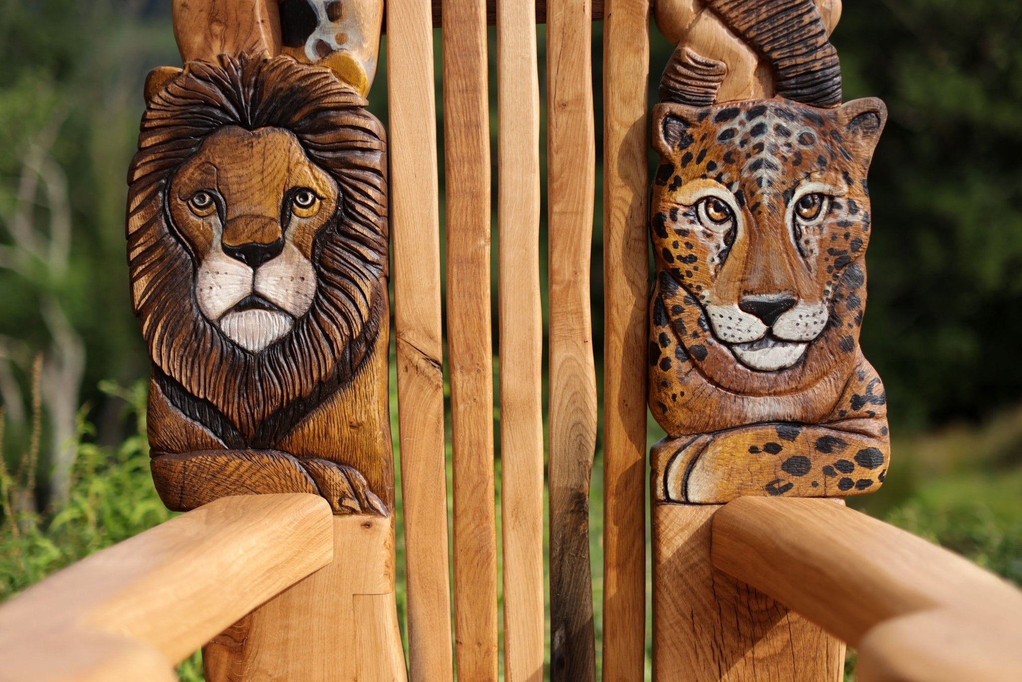 Wooden carvings of a lion and a leopard on a natural background