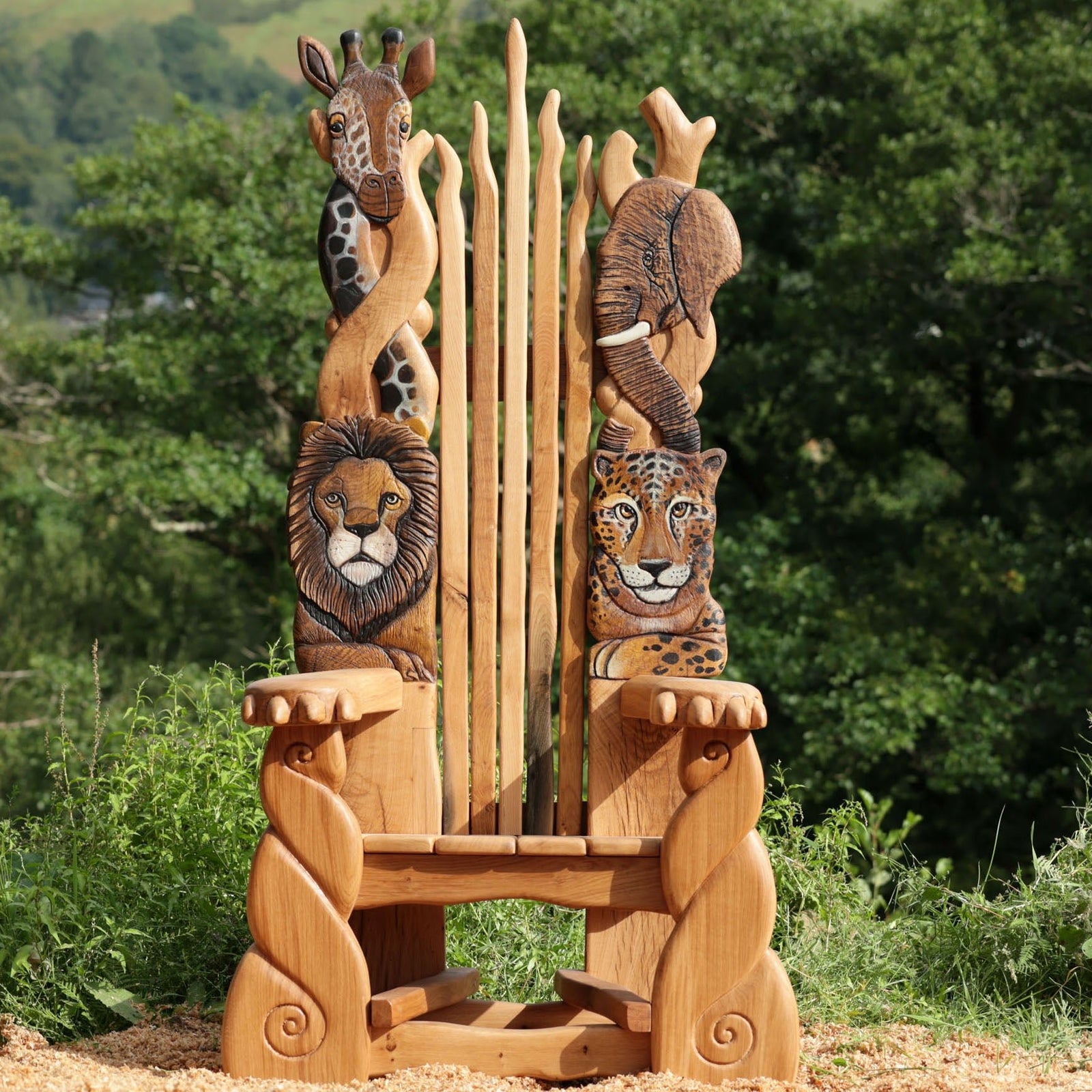 Wooden chair with animal carvings in a natural setting

