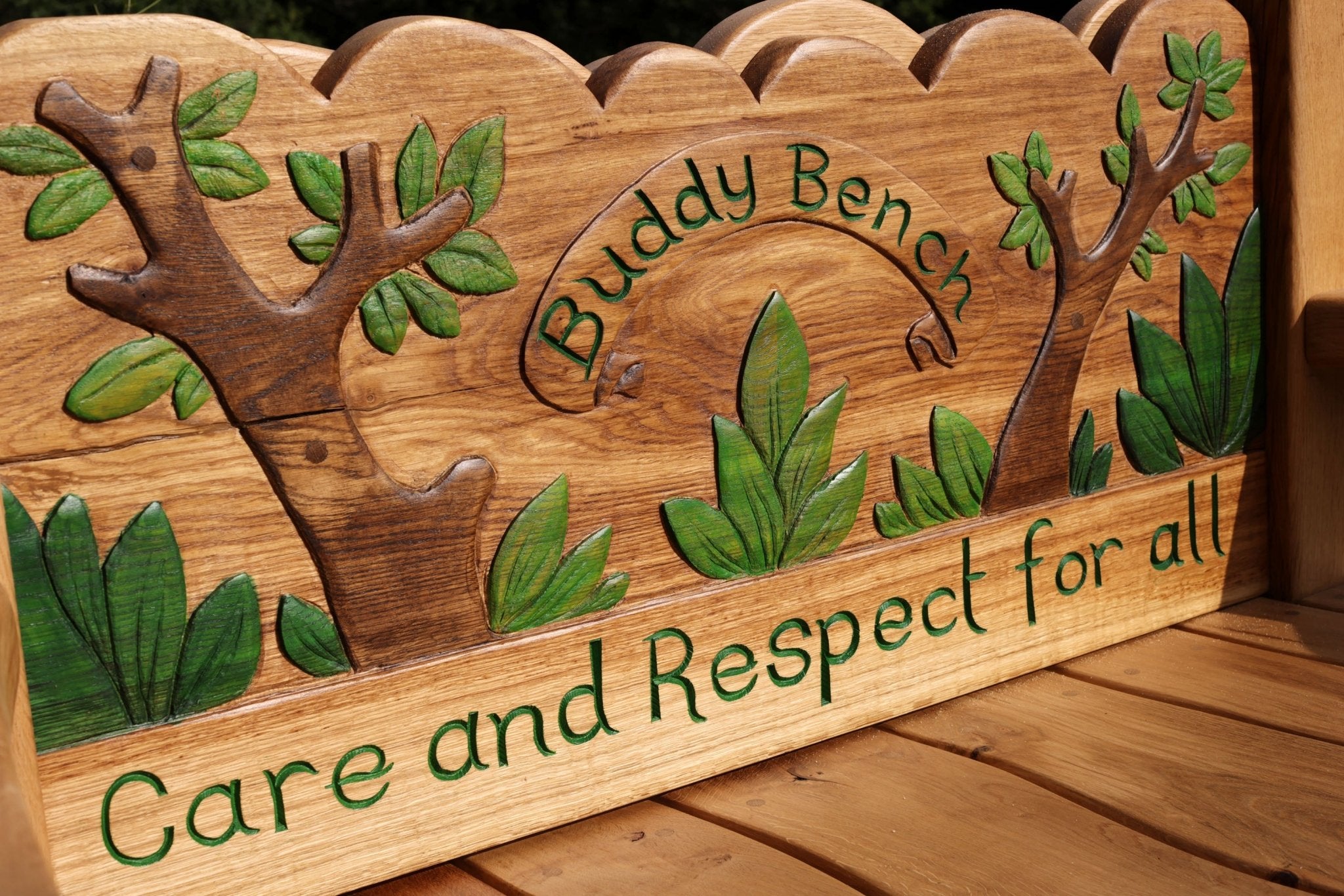 detailed view of buddy bench backrest with painted leaves and motto