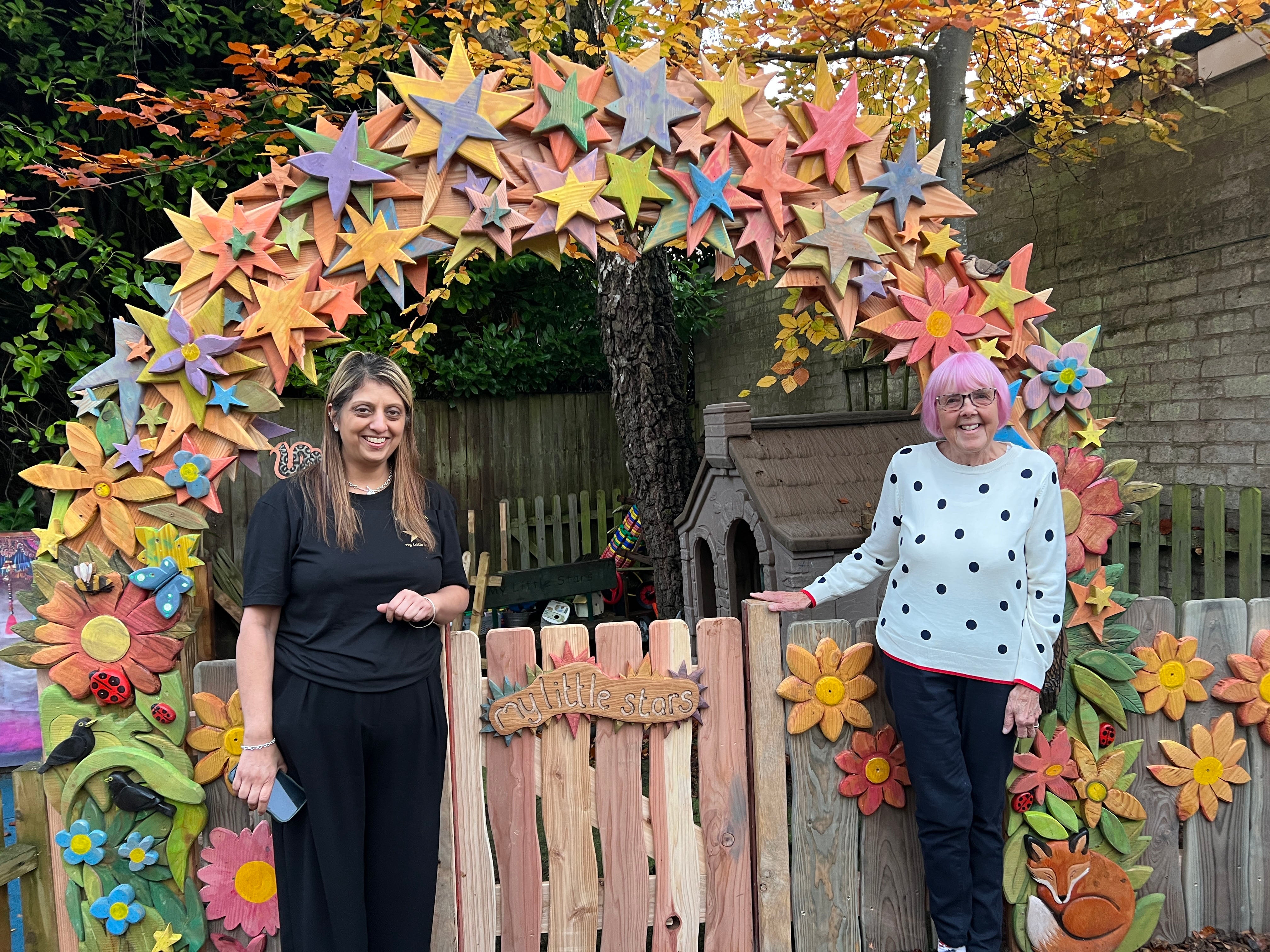 Free Range Designs team installing the colourful wooden arch at My Little Stars Nursery in Coventry