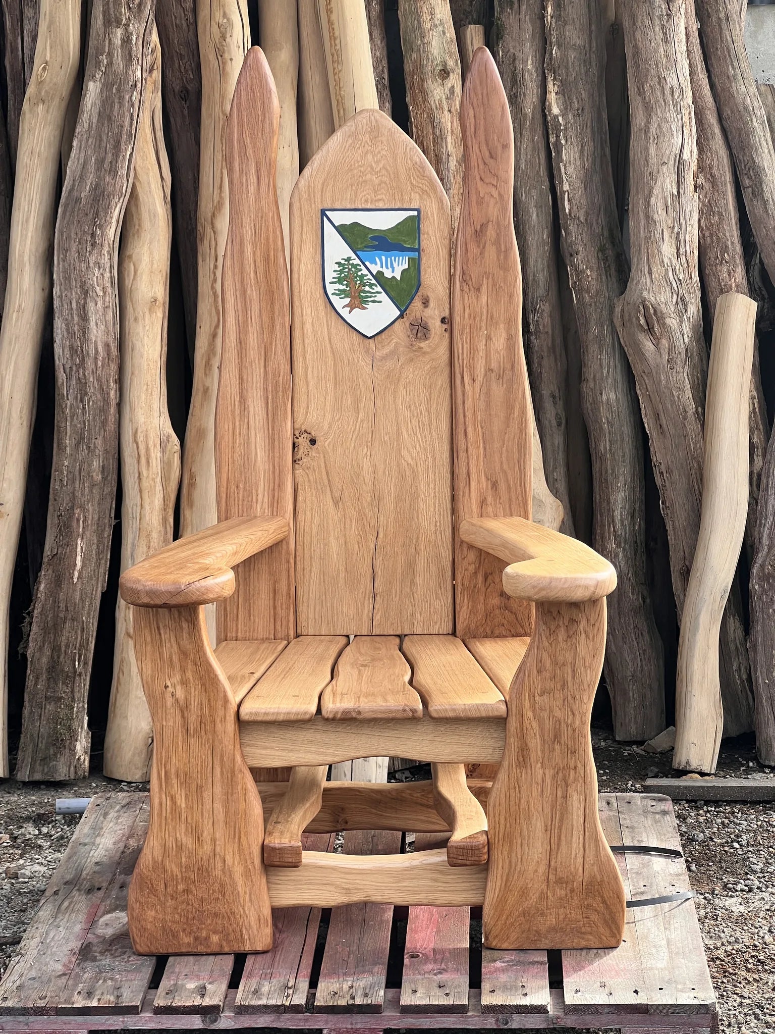 Hand-carved oak storytelling chair with the Rhayader Church in Wales Primary School crest