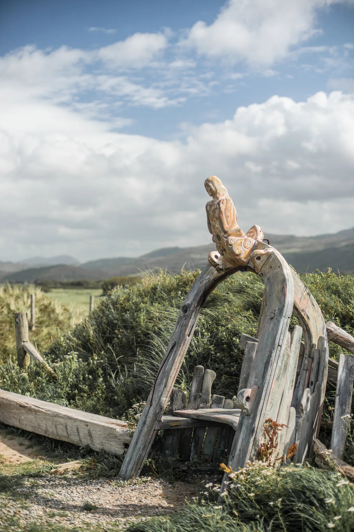 Side view of Shipwreck chair showing painted oak hull arch | wrecked ship aesthetic | Harlech sand dunes