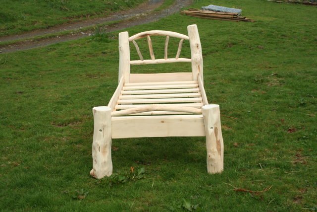 Handmade driftwood Flintstone-style single bed — carved natural wood, bespoke, Wales