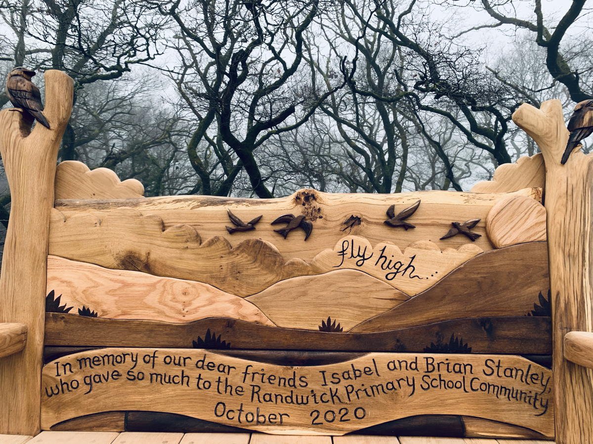Carved backrest of handmade oak skylark memorial bench — bespoke tribute seating, Wales