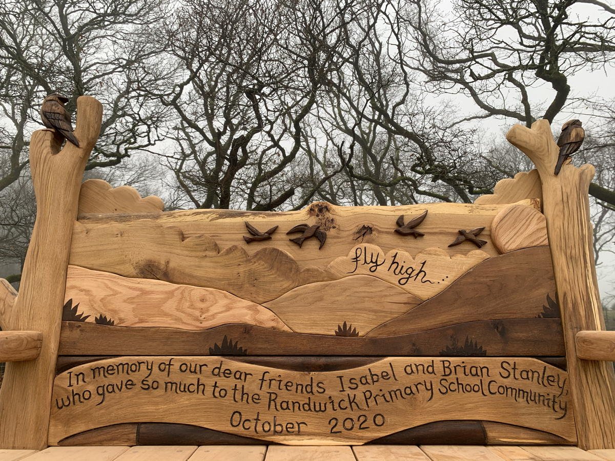 Carved skylark motif on handmade oak memorial bench — bespoke tribute seating, Wales