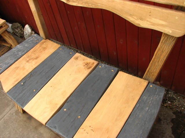 Handmade slate and oak garden bench close-up — bespoke natural stone and wood seating, Wales