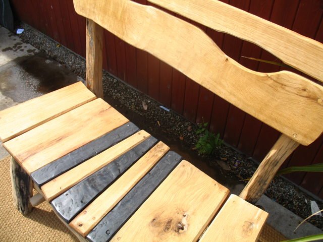Side view of handcrafted slate and oak garden bench — bespoke outdoor seating, Wales