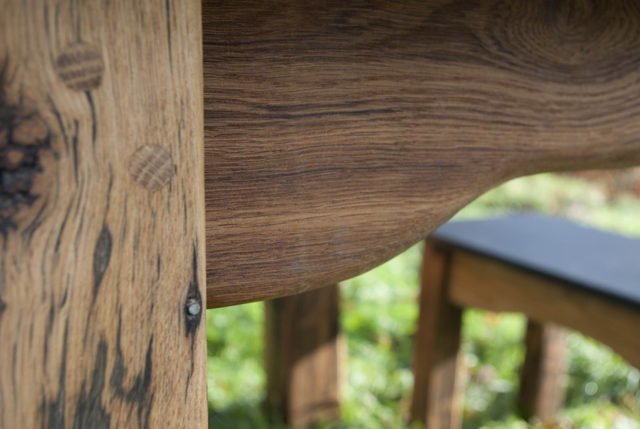 Mortise and tenon joint detail on handmade slate and oak garden table — Wales