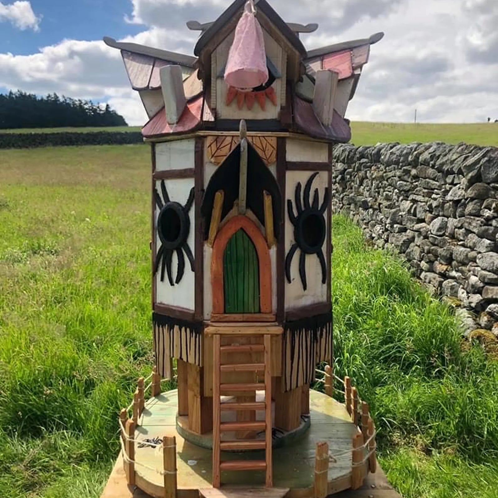 Handmade gothic spider fairy tower with dark painted walls, cobweb decorations and two-storey fairy design