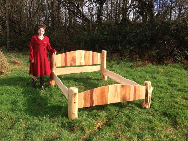 Handmade stripy driftwood bed close-up — colourful sustainable wood bedroom furniture, Wales