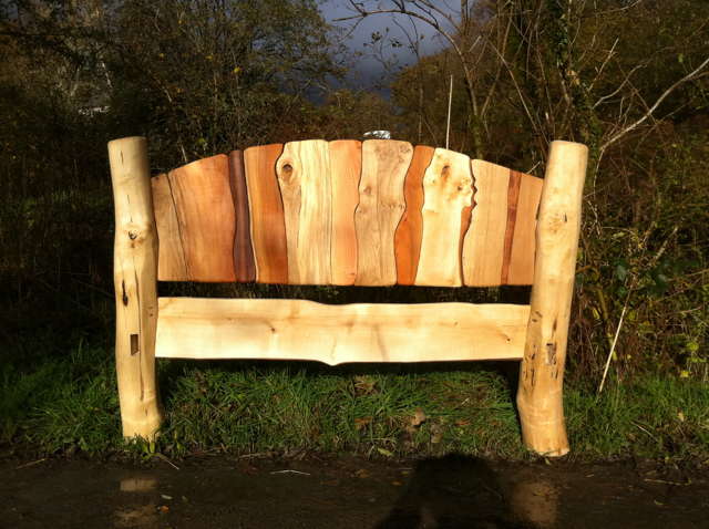 Handmade driftwood headboard on stripy bed — sustainable colourful wood bedroom furniture, Wales