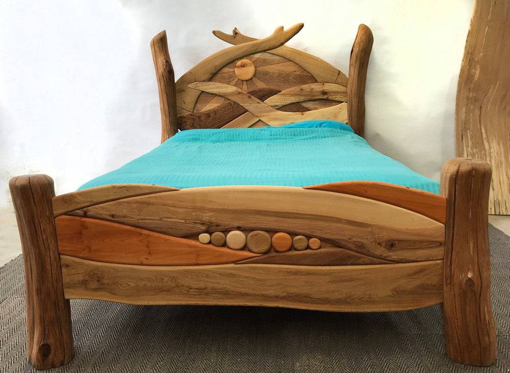 Handmade solid oak Sunrise Bed showing carved sunrise detail — bespoke furniture, Wales