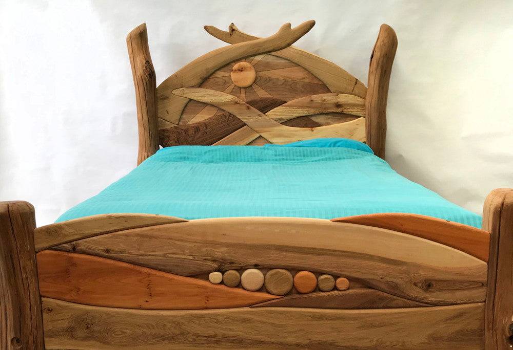 Handmade solid oak Sunrise Bed with carved sunrise headboard — bespoke Welsh furniture, Wales