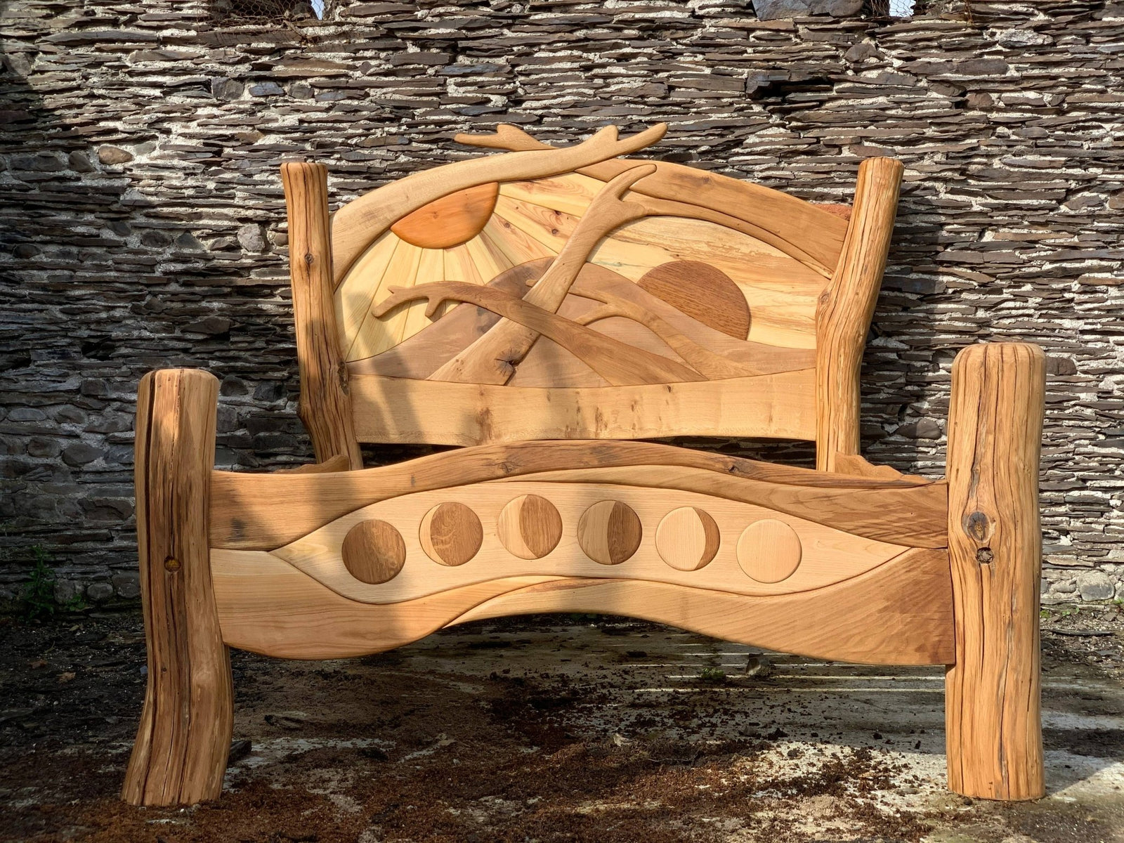 Funky curved solid oak Sunrise Bed — bespoke hand-carved wooden bed, handmade in Wales