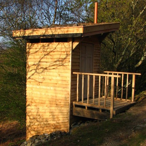 Tree bog composting toilet with timber frame in woodland setting — eco off-grid, Wales