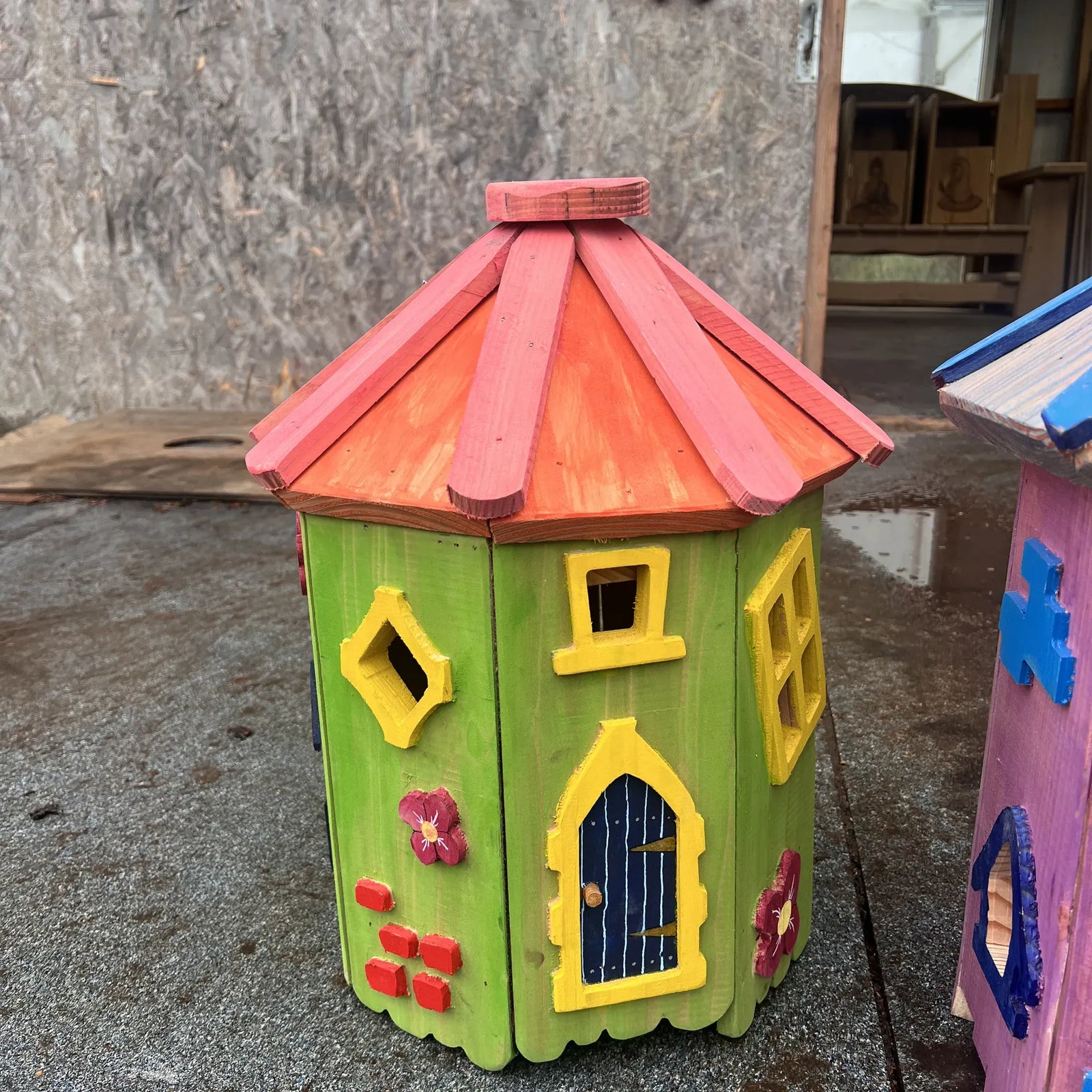 Handmade woodland tree fairy cottage with bark-on branch supports, multi-storey tower and carved timber detail