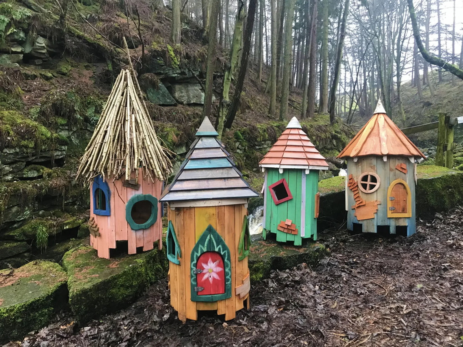 Mid-angle view of woodland tree fairy cottage showing layered floors and bark branch supports
