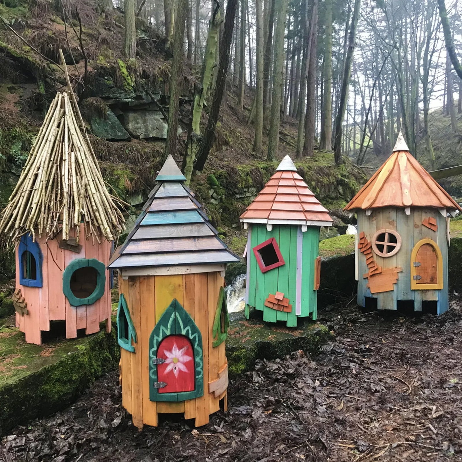 Close-up of tree fairy house door and ground level with natural timber and hand-carved wooden details