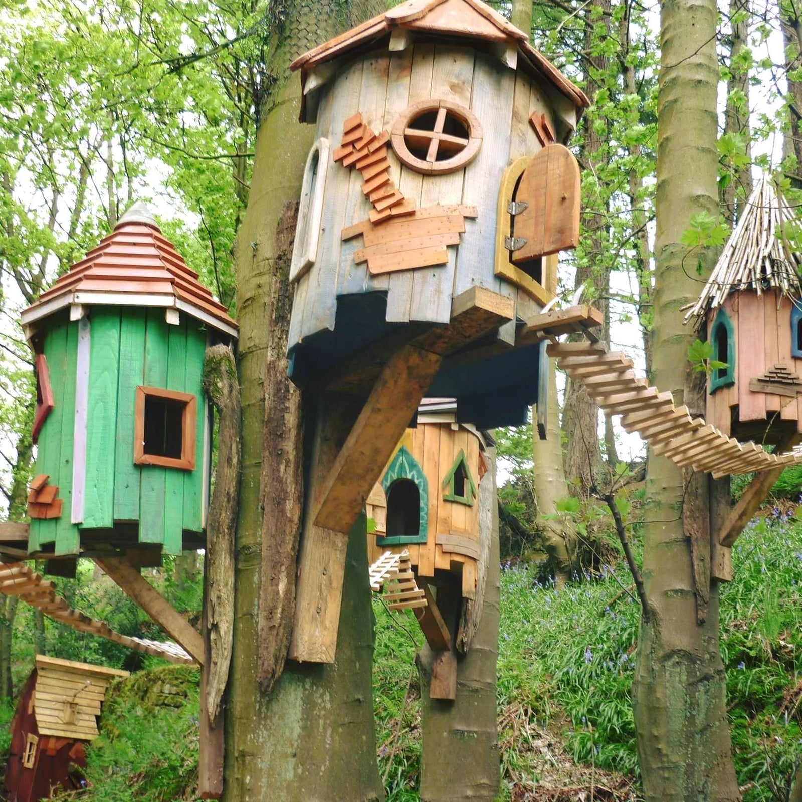 Upper section detail of tree fairy house showing handmade balcony and bark-on branch construction
