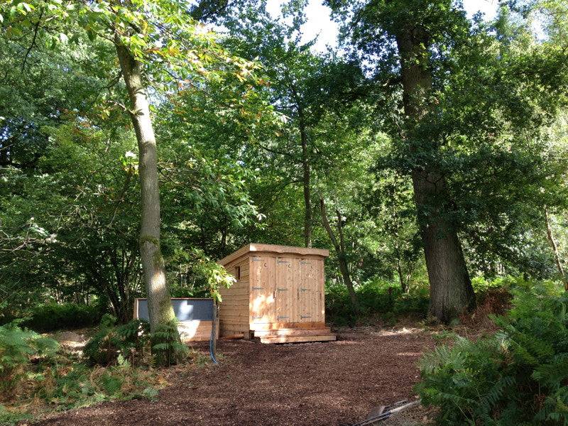 Triple composting toilet block in woods — handmade eco sanitation facility, Wales