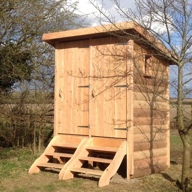 Twin composting toilet unit exterior view — handmade eco outdoor facility, Wales