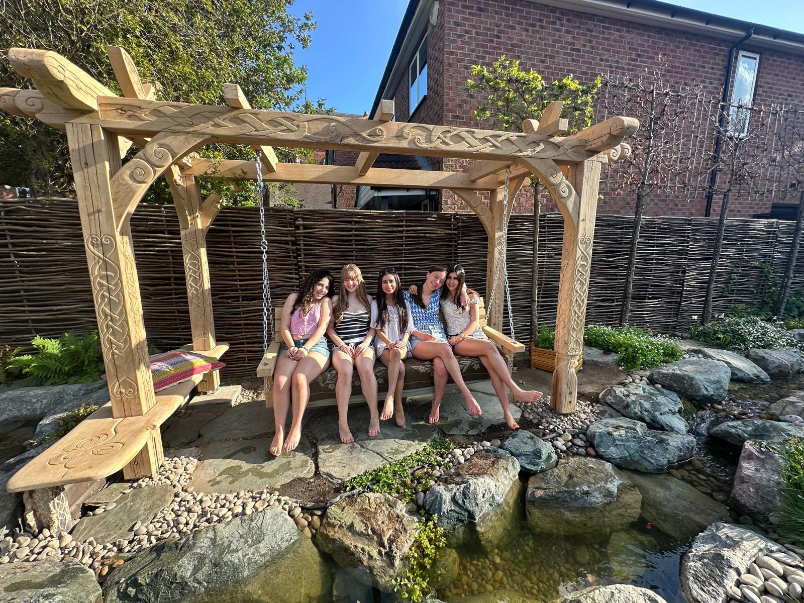 Full view of the bespoke Viking oak garden arbour with swing bench, commissioned by a Danish client in London