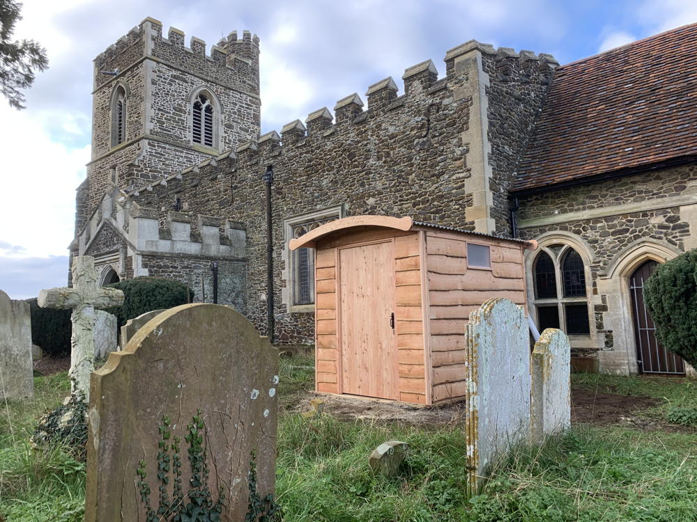 Compost toilet beside historic church building