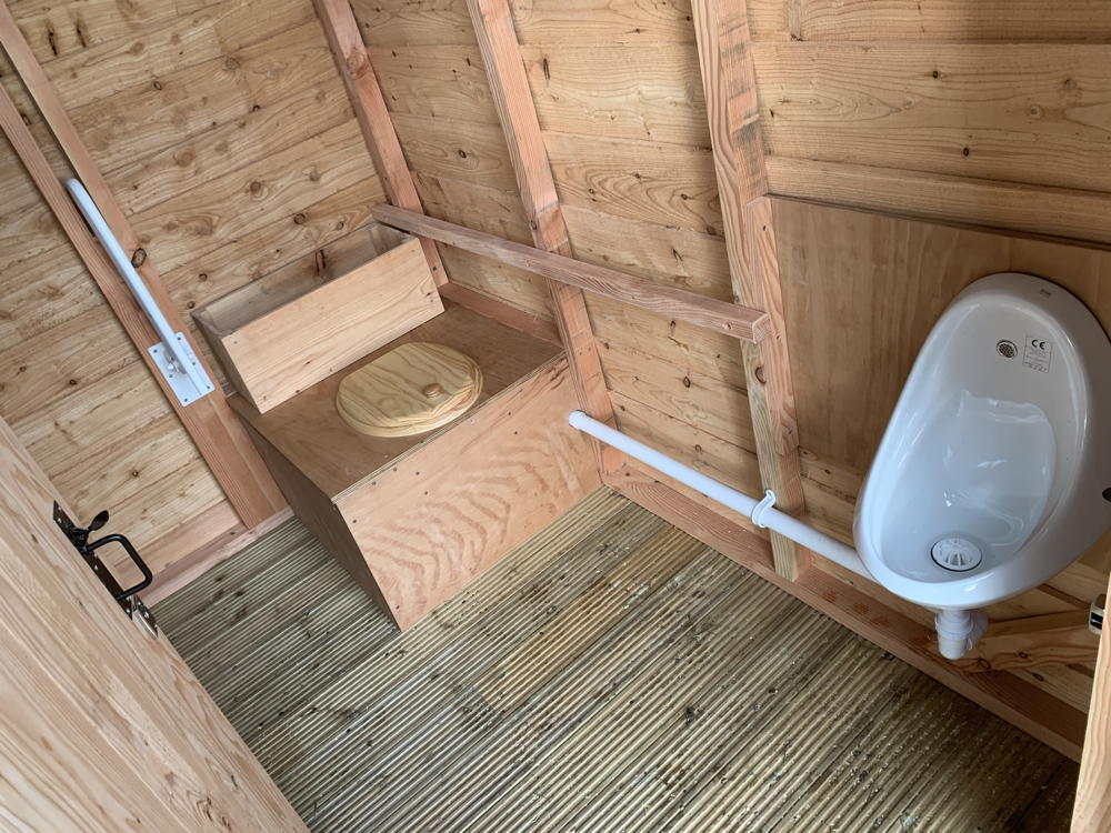 Interior view of compost toilet with urinal