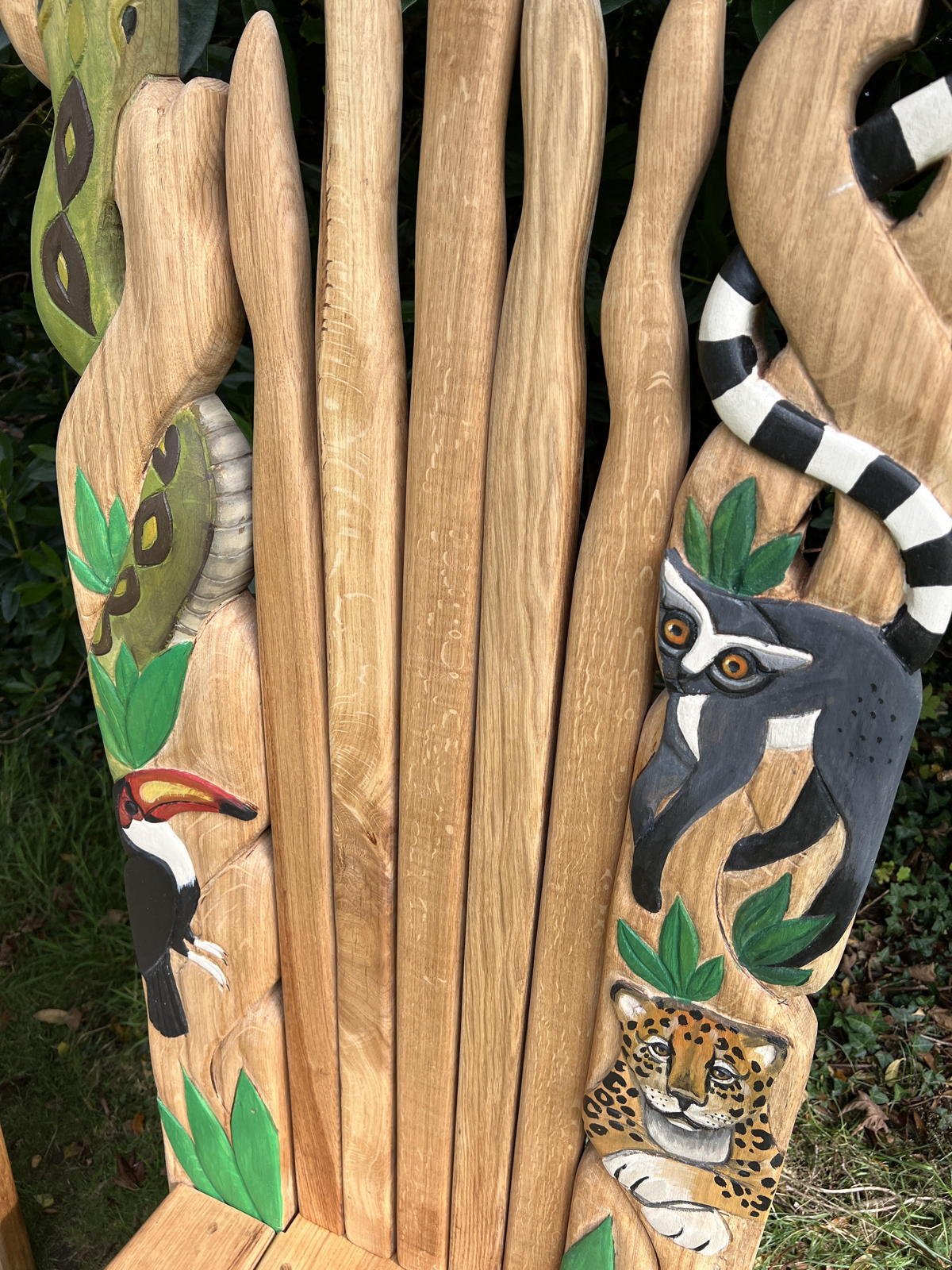Jungle-inspired carved oak throne with toucan, jaguar and lemur — handmade wildlife chair, Wales