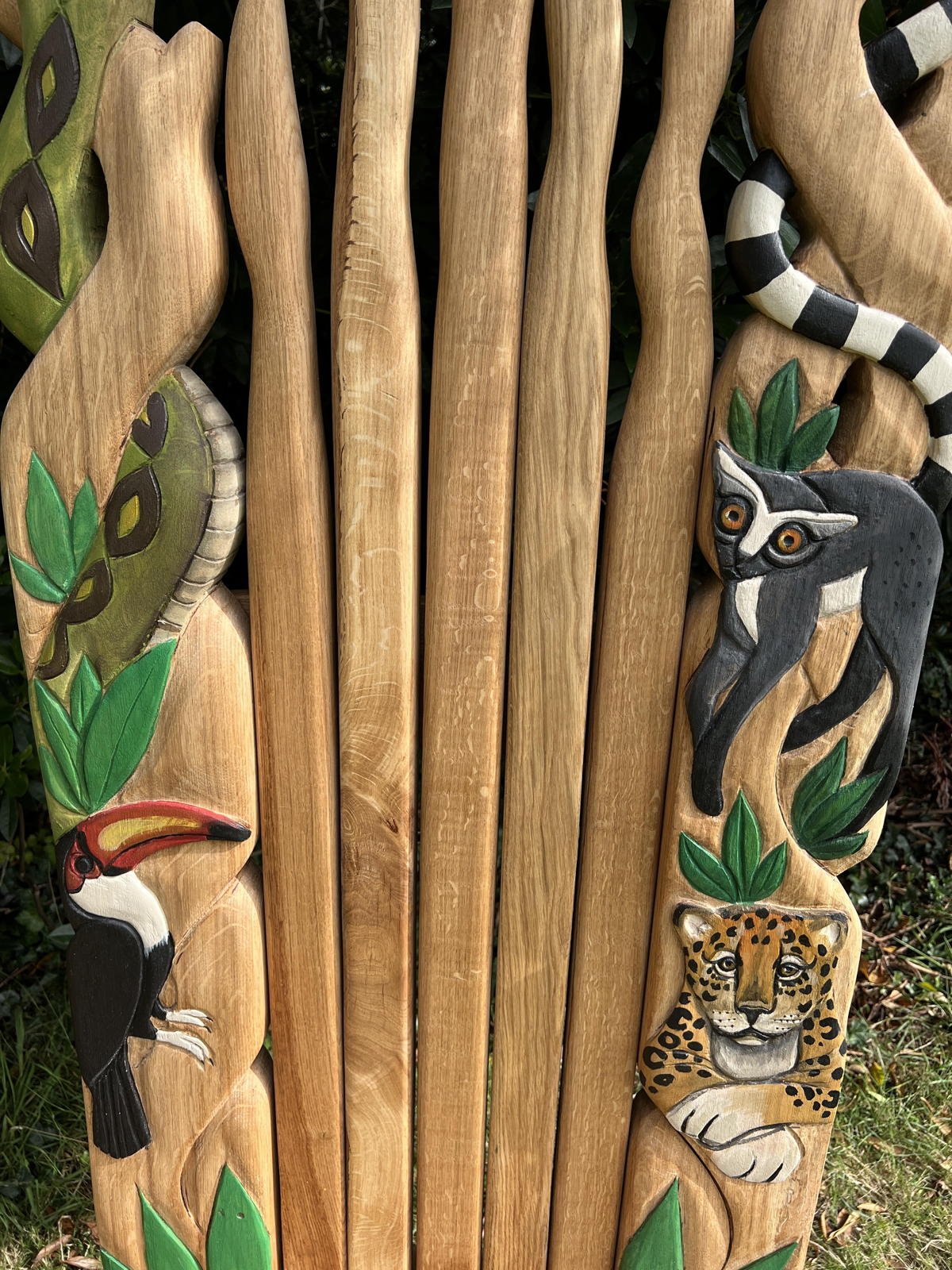 Carved oak throne detail with toucan, jaguar and lemur — handmade jungle wildlife chair, Wales