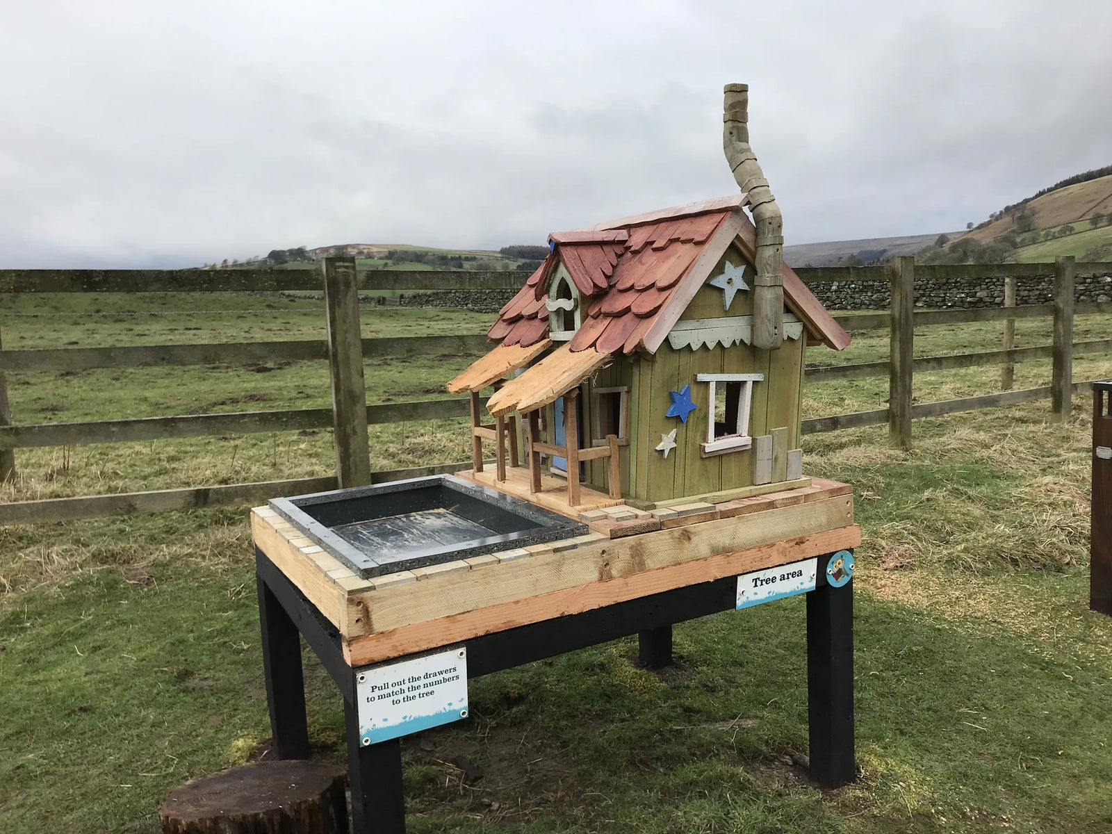 Side view of fairy wishing cottage showing red roof tiles and reclaimed timber cottage walls