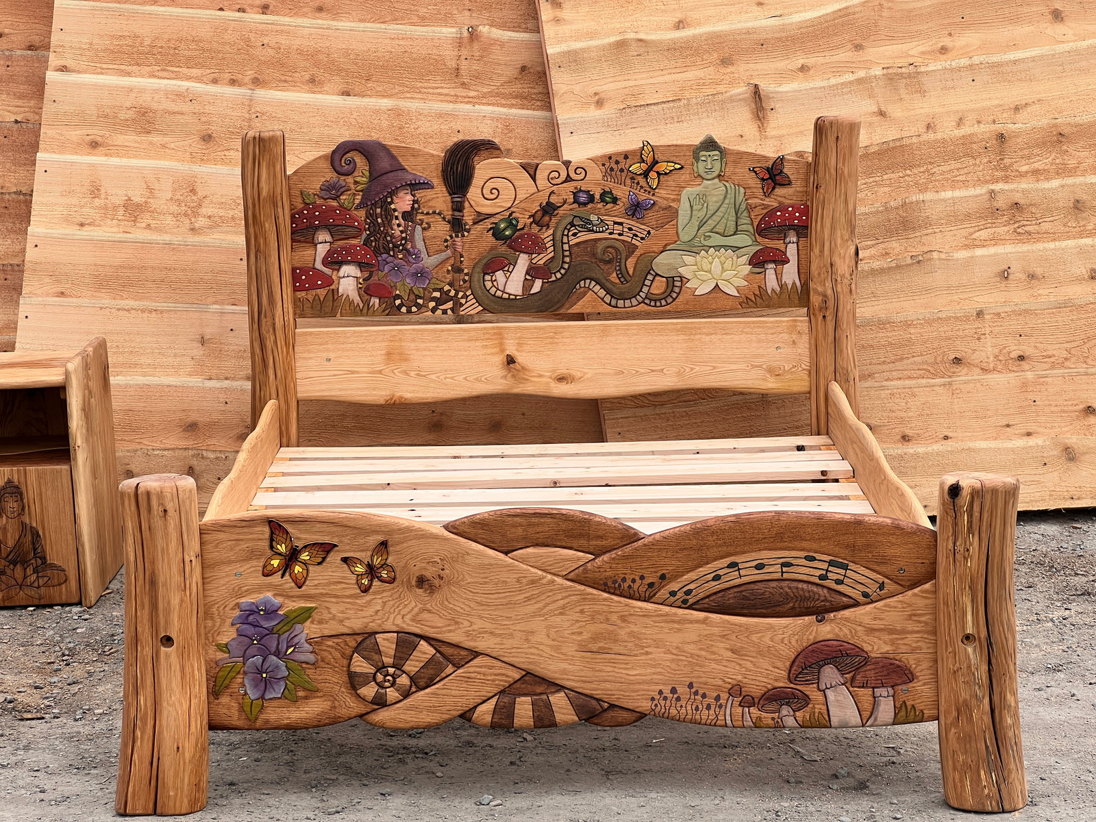 Deep relief Celtic braid knotwork carved into solid oak footboard with painted butterfly and mushroom details