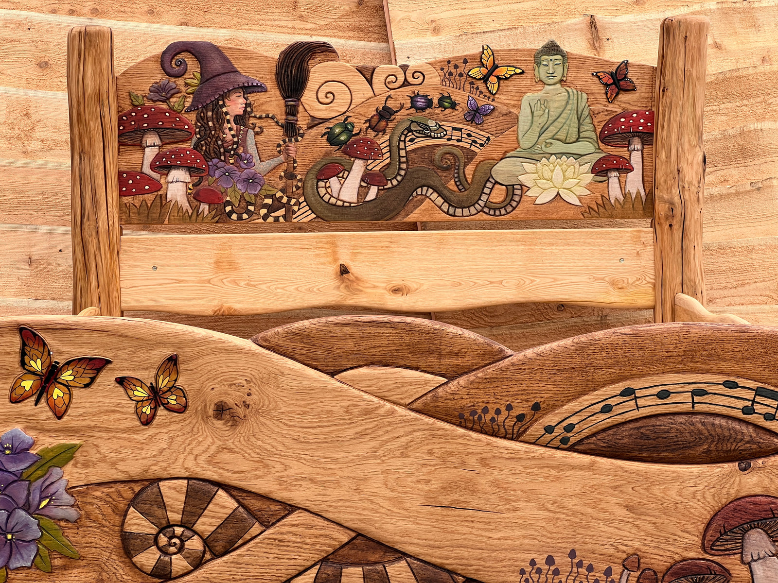 Hand-carved and painted Buddha meditating on cream lotus flower — detail from solid oak fantasy bed headboard