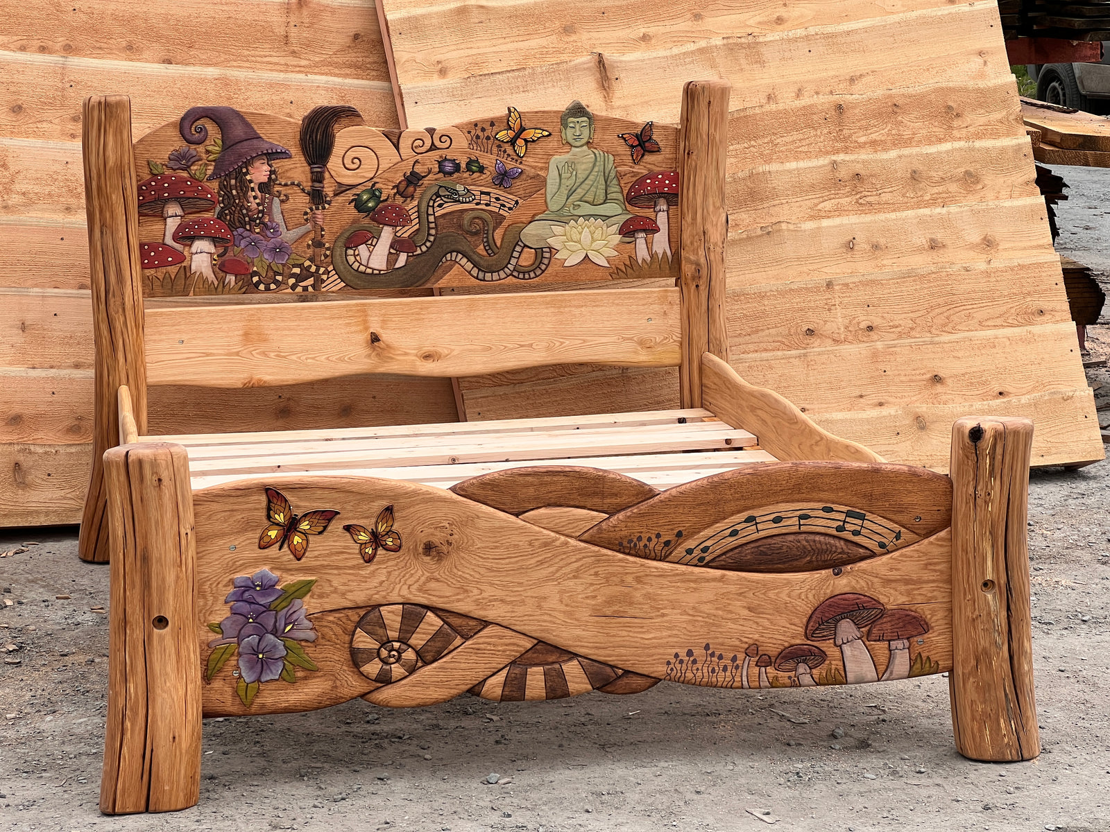 Full view of hand-carved fantasy king bed with rustic bark-texture oak posts and painted carved headboard