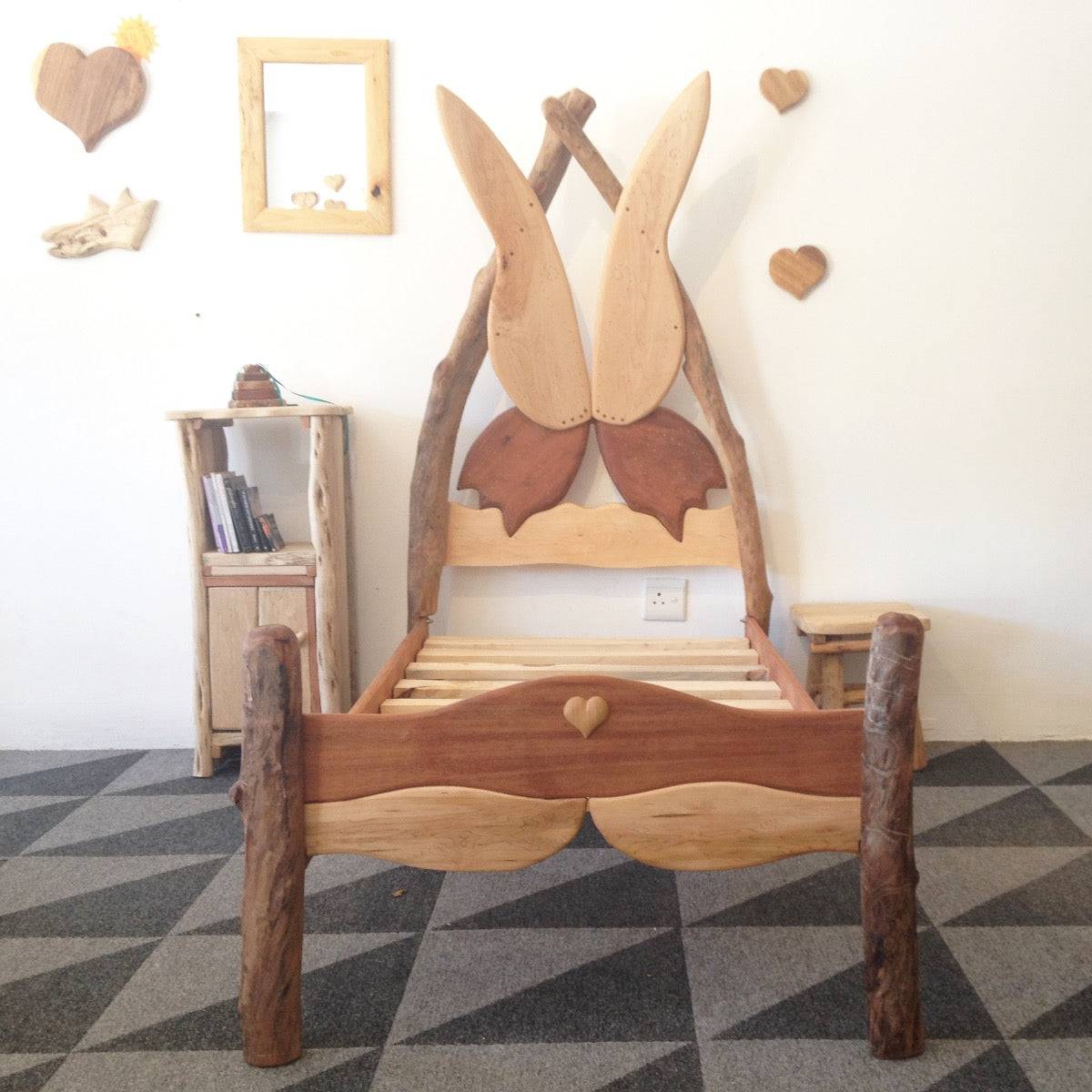 Handmade Wooden Fairytale Butterfly Bed crafted from local timber and driftwood, featuring a whimsical butterfly wing design for a magical bedroom experience.
