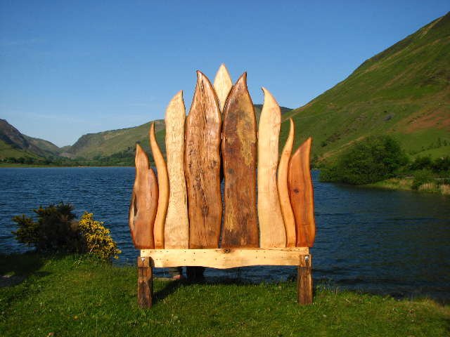 Handcrafted oak flame bed at Tal y-llyn lake — Viking-inspired solid wood furniture, Wales