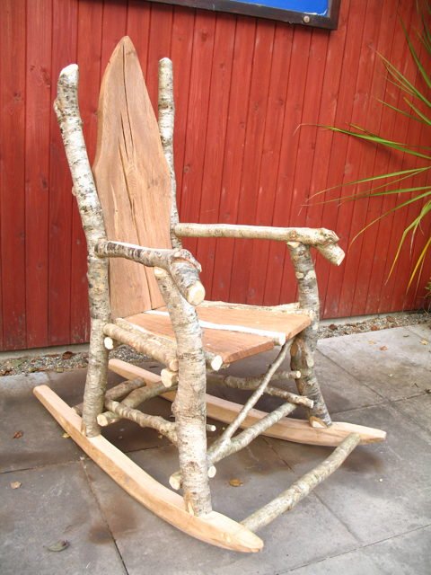 Front view of handcrafted rustic wooden rocking chair — natural branch design, made in Wales