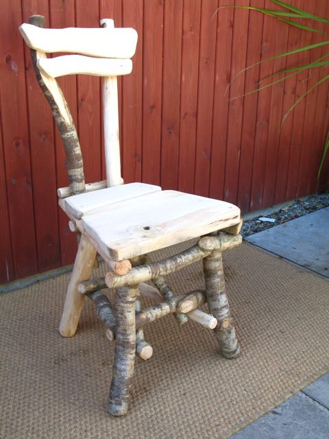 Carved woodland dining chair in oak and hazel — handmade in Wales