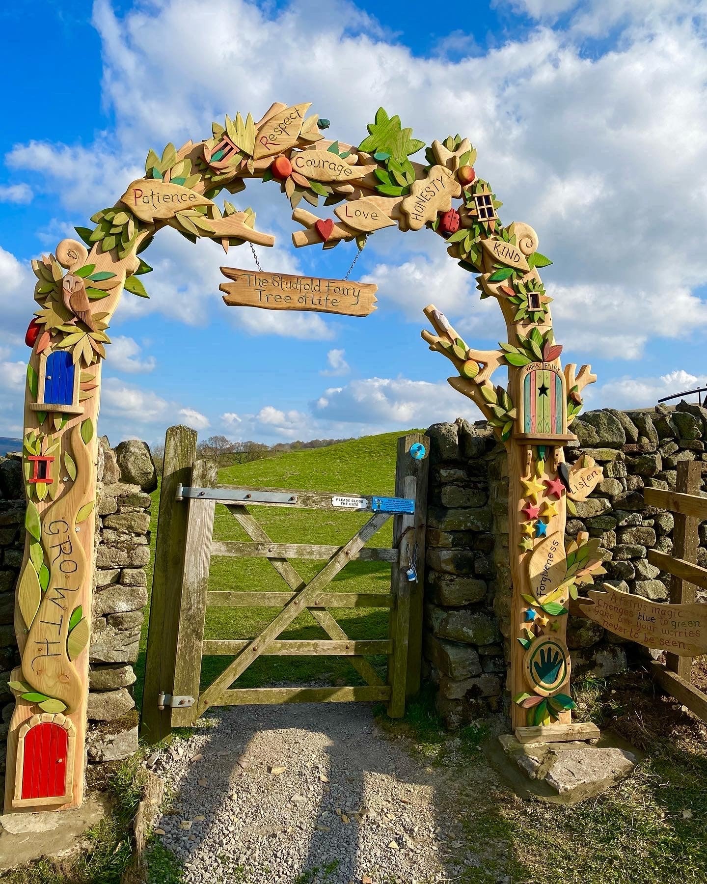 Colorful wooden archway entrance to Studfold Trails