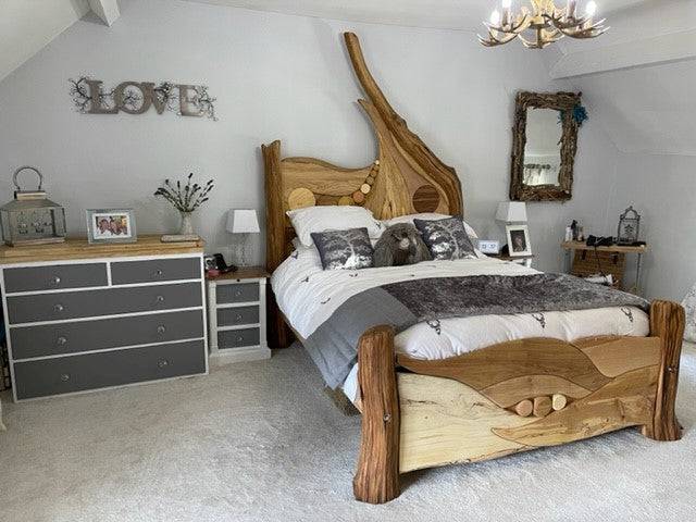 Rustic driftwood bed in elegantly decorated bedroom