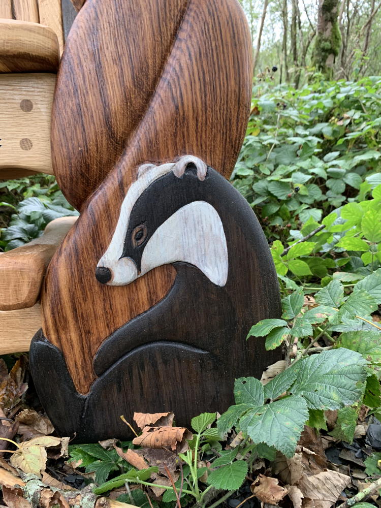 Close-up of badger carving on wooden chair