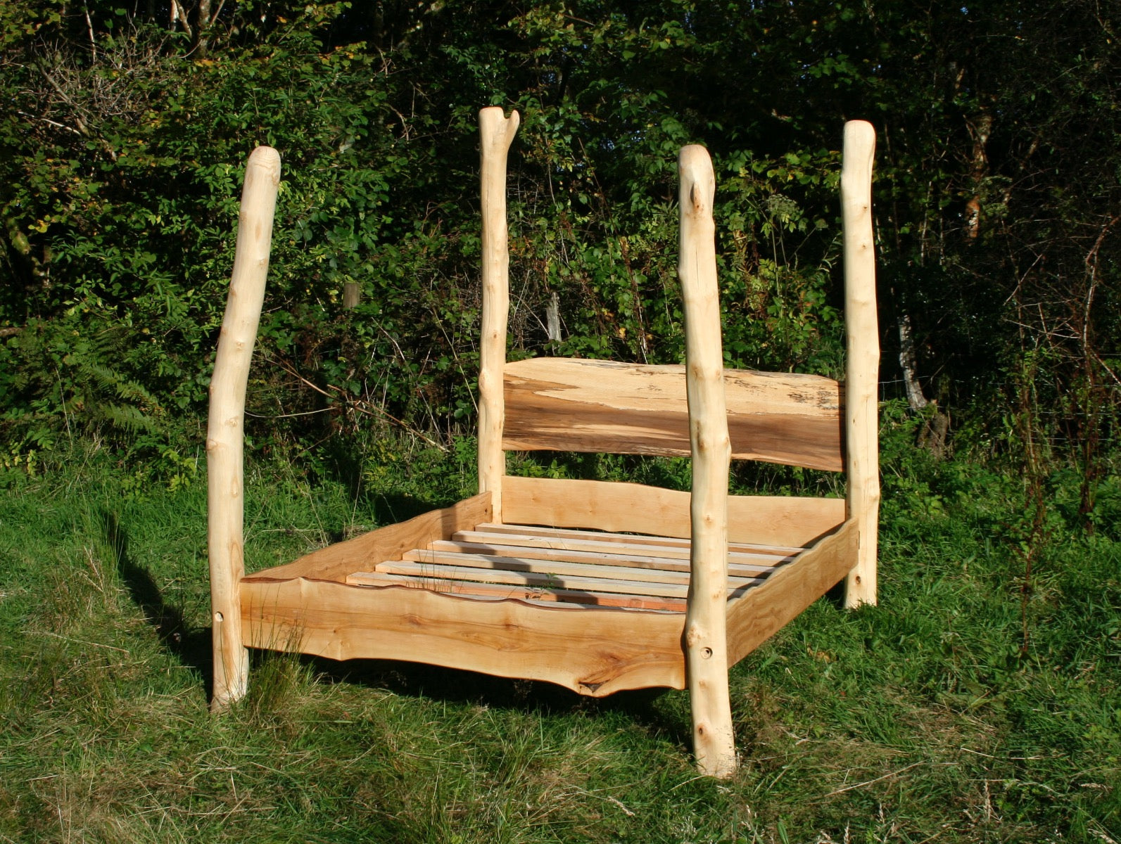 Handcrafted driftwood four poster bed outdoors