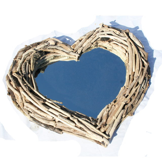 Heart-shaped driftwood mirror on white background