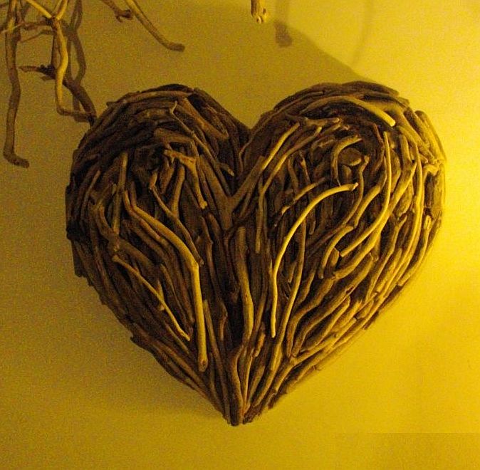 Driftwood heart sculpture with warm lighting