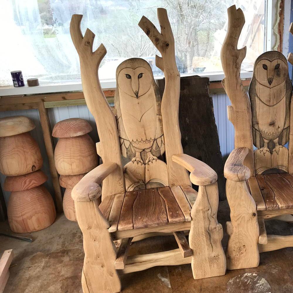 Pair of carved owl storytelling chairs indoors