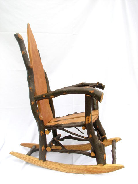 Side view of rustic wooden rocking chair with branch arms