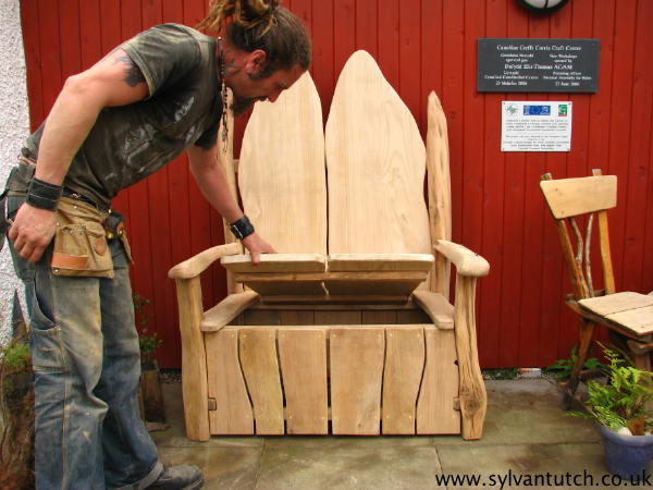 Man opening garden storage bench seat