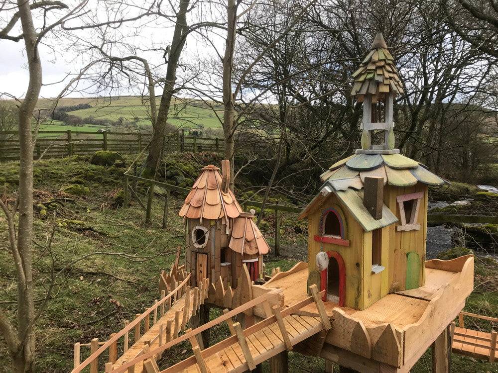 Fairy houses with bridges in a natural setting